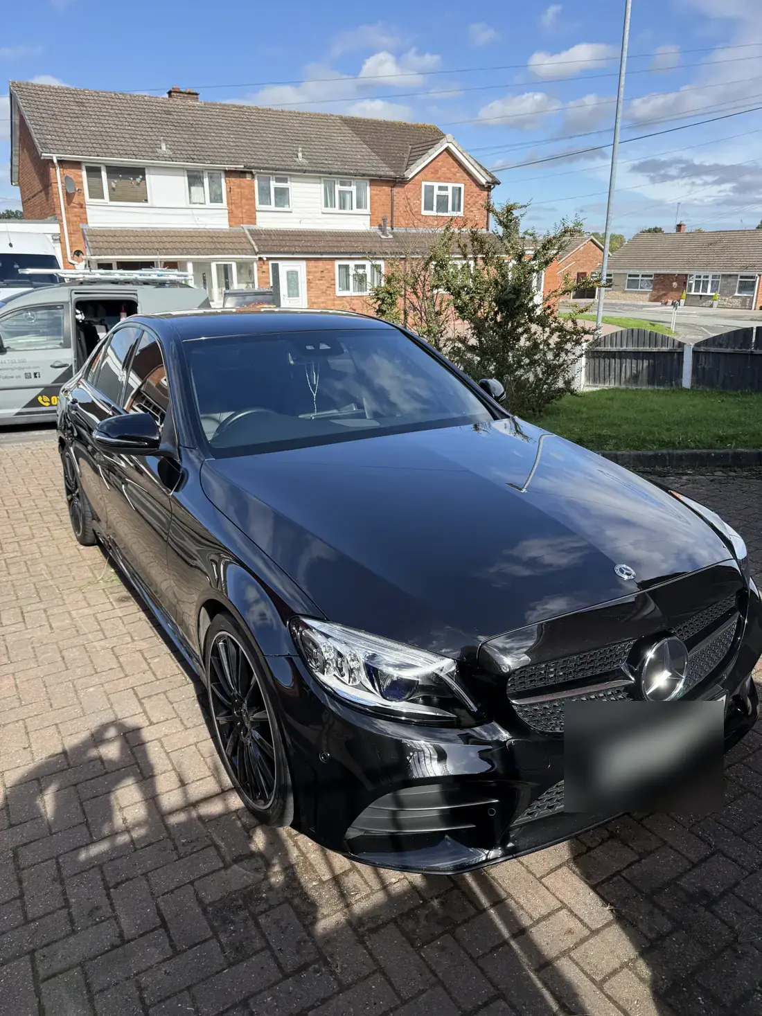 Black Mercedes C-Class on a driveway after a polish